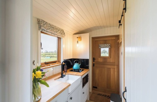 Menai Bridge Apartment | Luxury Shepherds Hut with hot tub, firepit and gas barbeque