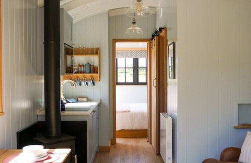 Menai Bridge Apartment | Luxury Shepherds Hut with hot tub, firepit and gas barbeque