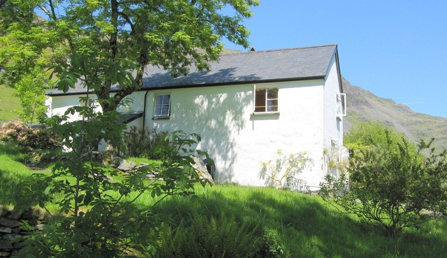 Traditional 18th century farmhouse on the slopes of a mountain